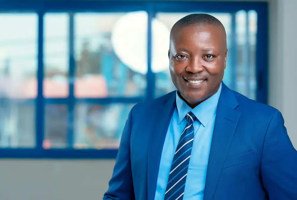 A smiling Kenyan property agent